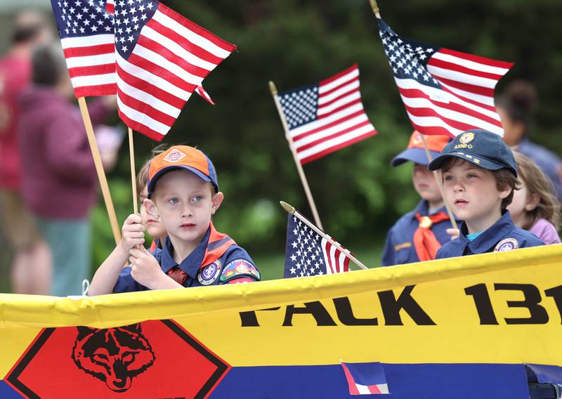 Members of Cub Scout Pack 131 walk down West Locust Street during the DeKalb Memorial Day parade Monday, May 27, 2024, as it heads to Ellwood House where a ceremony was held wrapping up the day’s events.