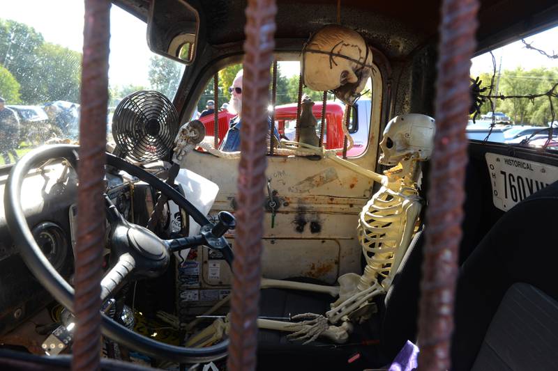 Guy Quandt of Rock Falls walks past a "Rat Rod" owned by Bob Renwick of Rockford at the Focus House Foundation Car Show held during Autumn on Parade on Satirday, Oct. 7, 2023 in Oregon. Renwick's 1956 Ford was decorated with several skeletons.