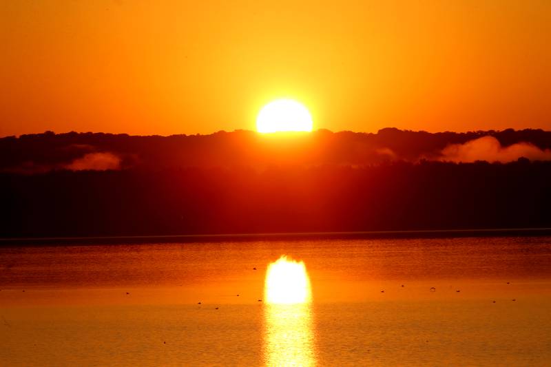 The sun rises over Senachwine Lake on Saturday, Sept. 2, 2023 near Putnam.