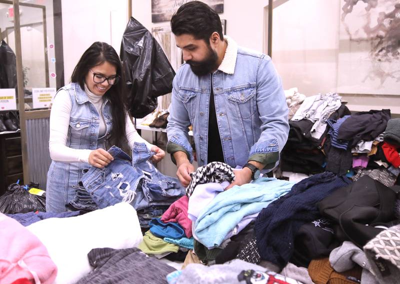 Sycamore husband and wife Edgar and Daisy Arias, the founders of Creating Blessings, go through some of the donated items Tuesday, Feb. 13, 2024, at Studio 25 in Sycamore. Creating Blessings is a community garage sale where everything is free for anyone with a need.