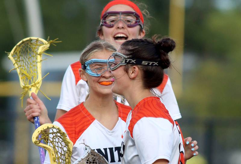 Crystal Lake Central’s Anna Starr, back, and Claire Warren, middle, congratulate teammate Colleen Dunlea, front, after Dunlea’s goal against Lake Forest during girls lacrosse supersectional action at Metcalf Field on the campus of Crystal Lake Central Tuesday.