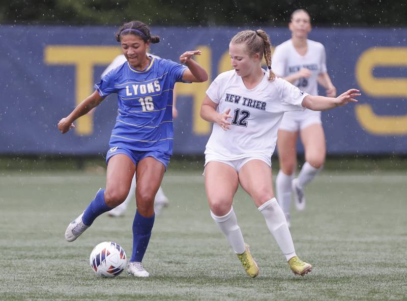 New Trier's Clara Deliduka (12) fights for the ball against Lyons' Leahla Frazier (16) during the Class 3A Dominican super-sectional between New Trier and Lyons Township in River Forest on Tuesday, May 28, 2024.