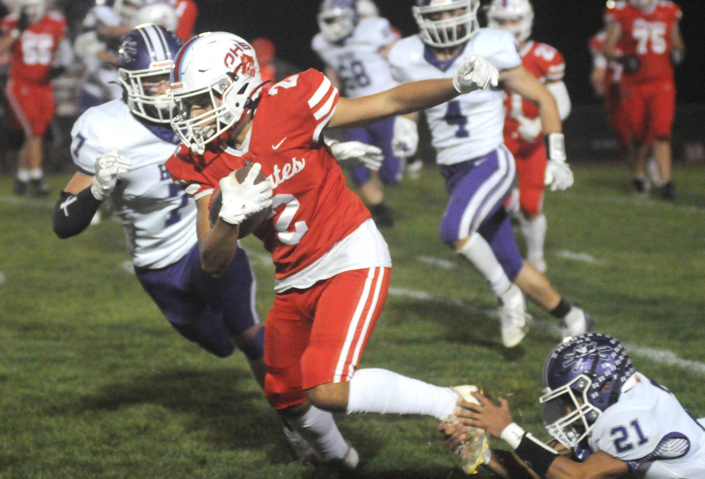 Rochelle's Ethan Goodwin and Xavier Villalobos (21) take down Ottawa's Andrew Vercolio at King Field on Friday, Oct. 18, 2024.