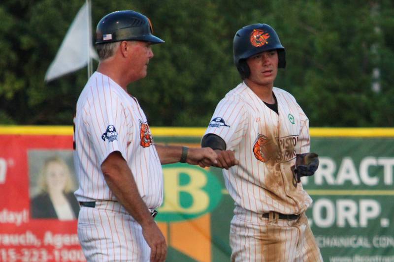 Kyle Gibson Fist Bumps Manager John Jakiemiec after reaching third base on Thursday, August 1, 2024 at Veterans Park in Peru.