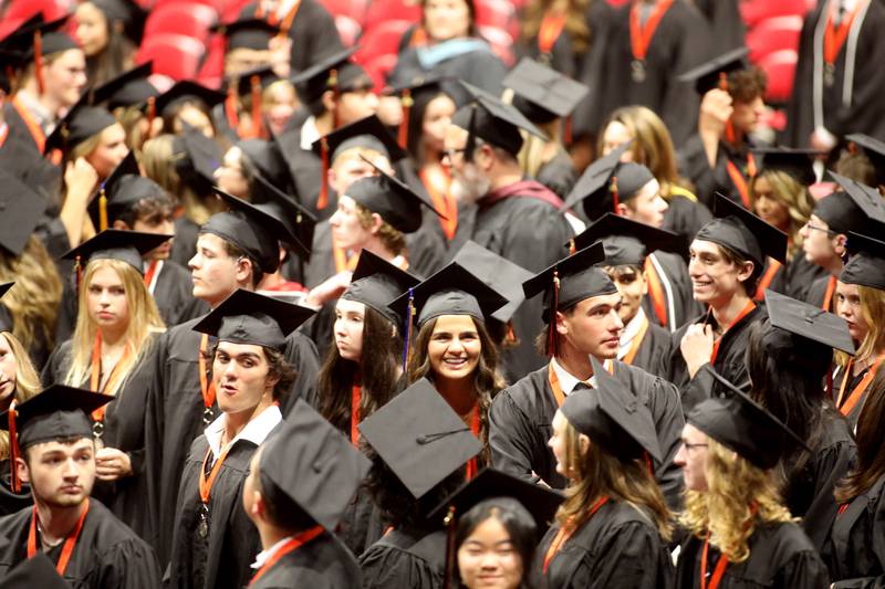 St. Charles East graduates look for their loved ones in the stands during the school’s 2024 commencement ceremony at Northern Illinois University in DeKalb on Monday, May 20, 2024.