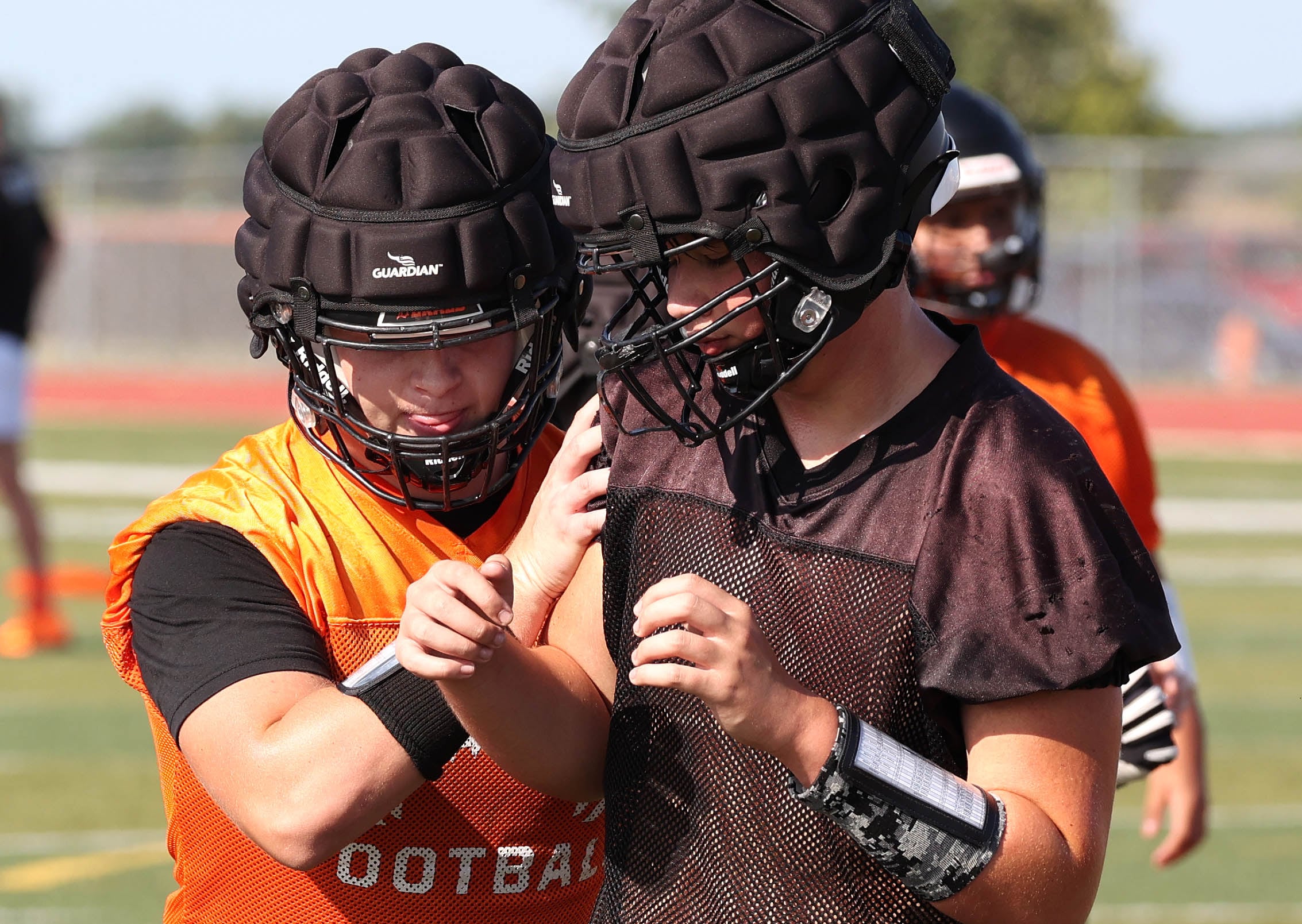 Dekalb’s Owen Sisson (left) goes through a drill Monday, Aug. 12, 2024, at the school during the first practice of the regular season.