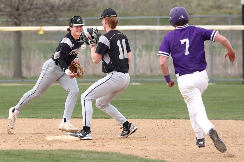 Sycamore's Nathan Lojko flips the ball to Teague Hallahan to record a force out on Rochelle's Brode Metzger during their game Wednesday, April 10, 2024, at Rochelle High School.