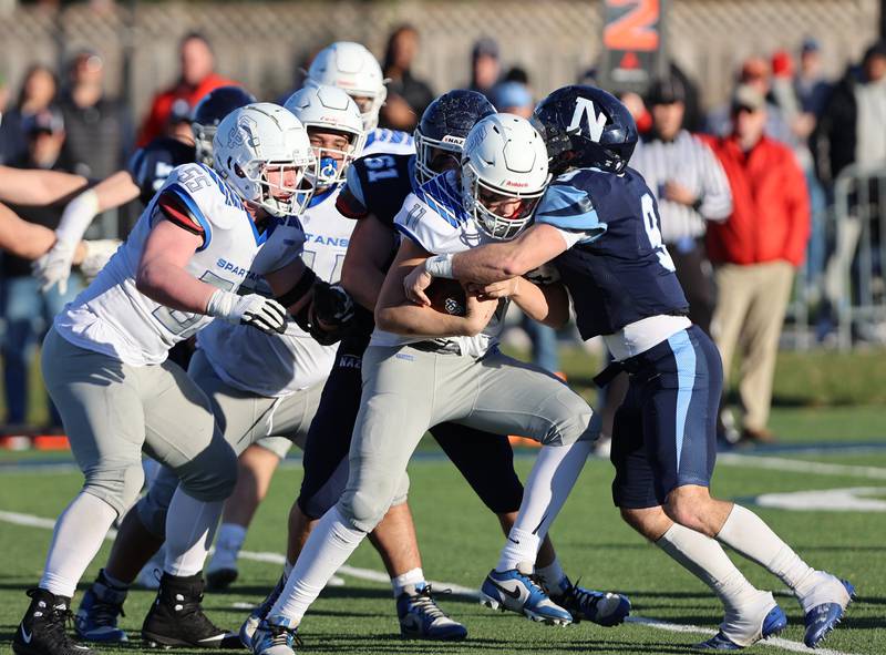 St. Francis' Alessio Milivojevic (11) is stopped by the Nazareth defense during the boys varsity IHSA 5A semifinal between Nazareth Academy and St. Francis high school in La Grange Park, IL on Saturday, Nov. 18, 2023.