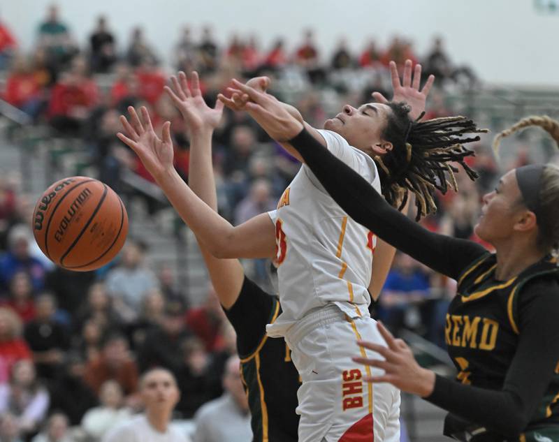 Batavia’s Addison Prewitt has her shot blocked by Fremd’s Ellie Thompson in the Bartlett supersectional game on Monday, Feb. 26, 2024.