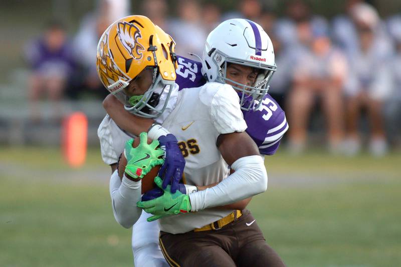 Hampshire’s Uriah Beamon, back, tackles Jacobs’ T.O. Boddie  in varsity football on Friday, Sept. 6, 2024, at Hampshire School in Hampshire.