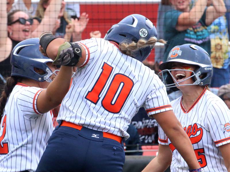 Oswego players Rhiana Martinez, Kiyah Chavez and Marissa Moffett react after scoring runs against Mundelein during the Class 4A third place game on Saturday, June 8, 2024 at the Louisville Slugger Sports Complex in Peoria.