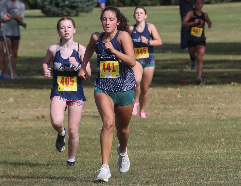 Fieldcrest's Macy Gochanour runs in front of teammate Hannah Schumacher (no.445) Gary Coates Cross Country Invitational on Saturday, Sept. 14, 2024 Zearing Park in Princeton.