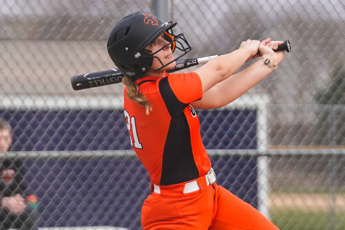 St. Charles East's Hayden Sujack (21) drives in a run on a double against Oswego East during a softball game at Oswego East High School on Wednesday, March 13, 2024.