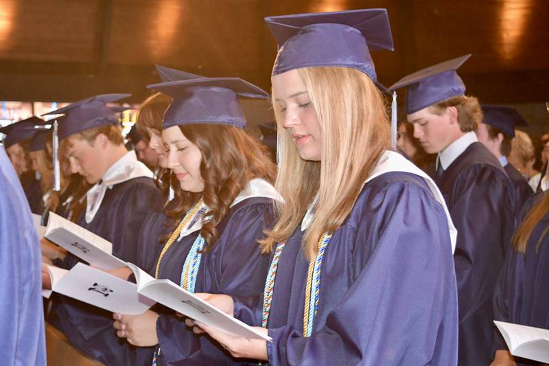 (Left to right) Nazareth Academy graduates Max Merchant, Alaina Milon, Gigi Montoro and Audrey Moster recite the alumni pledge during the school’s commencement ceremony at Christ Church in Oak Brook on Sunday, May 19, 2024.