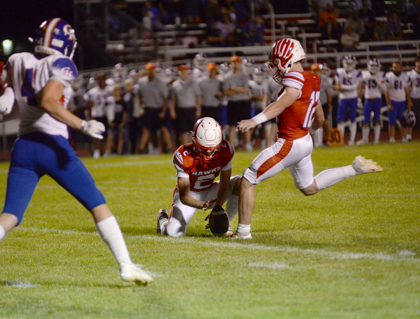 Oregon's Gavin Morrow (12) kicks a field goal as Cooper Johnson (2) holds the ball in the Hawks' 3-0 win over Genoa-Kingston on Friday, Sept. 13, 2024 at Landers-Loomis Field in Oregon.