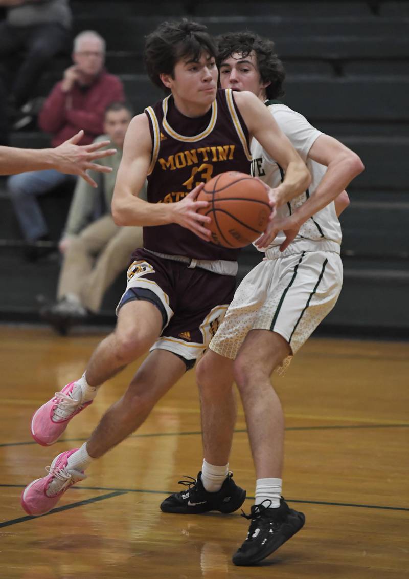 Montini’s Danny Petersen makes a move to get past St. Edward’s Josh Pottorff in a boys basketball game in Elgin on Thursday, Jan. 4, 2023.