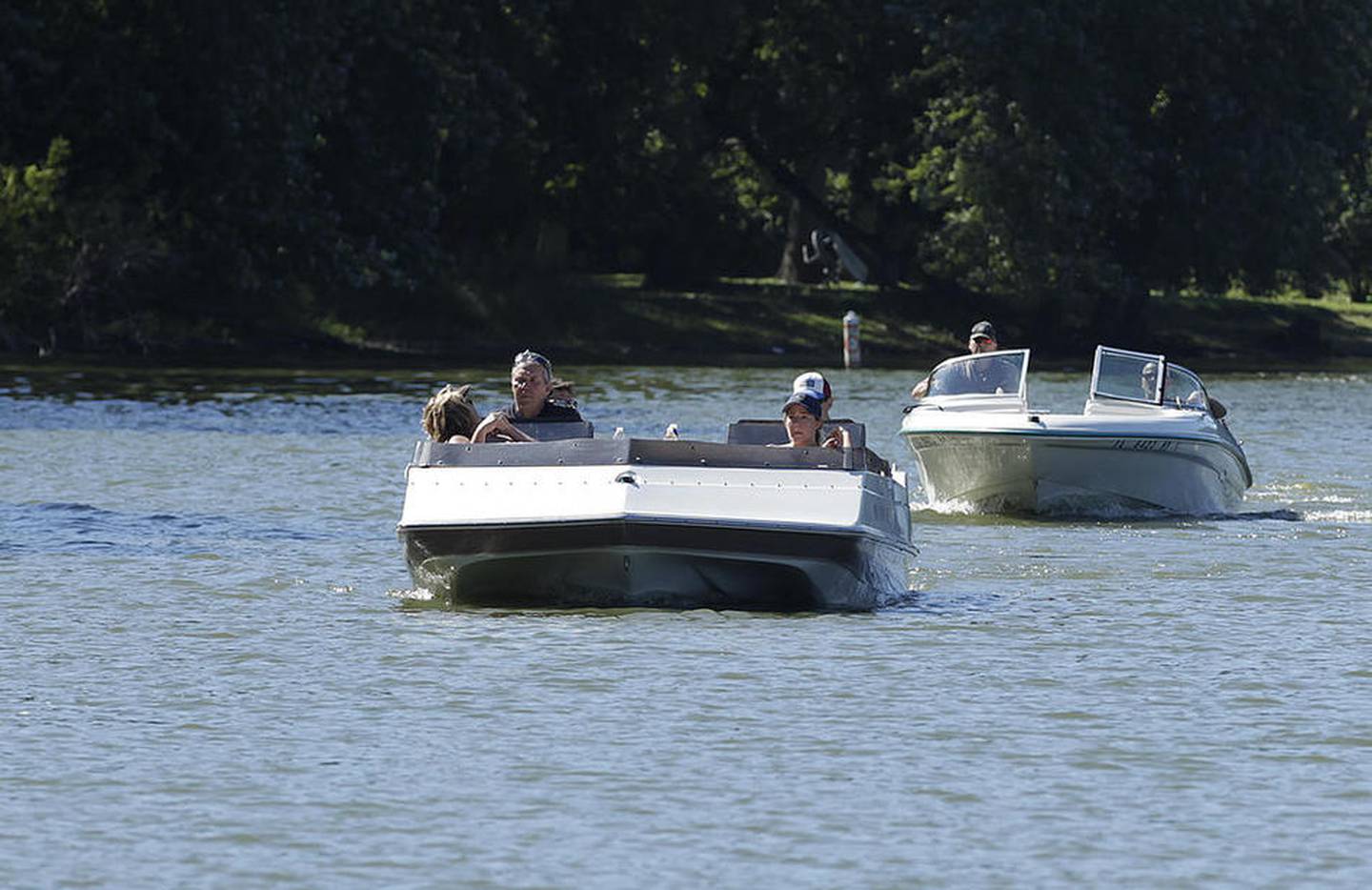 Boaters on the Fox River Friday, Sept. 2, 2016 observer the no wake zone south of the Stratton Lock and Dam near McHenry.