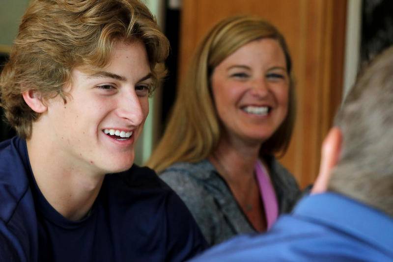 Cary-Grove pitcher Quinn Priester sits with his parents Andy, right, and Chris, back, as they discuss the previous night's MLB First-Year Player Draft on Tuesday in Cary. Priester was selected 18th overall by the Pittsburgh Pirates.