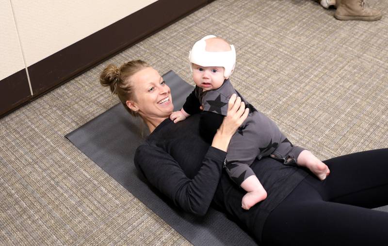 Danielle Slavinskas of St. Charles and her son, Milo, 6 months, participate in a baby yoga class at Northwestern Medicine Delnor Hospital in Geneva.