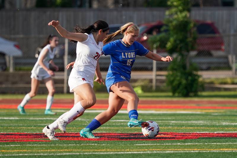 Lyons’ Zibby Mchaelson (15) plays the ball against Hinsdale Central's Adriana Giannini (21) during a Class 3A Hinsdale Central Sectional semifinal soccer match at Hinsdale Central High School in Hinsdale on Tuesday, May 21, 2024.