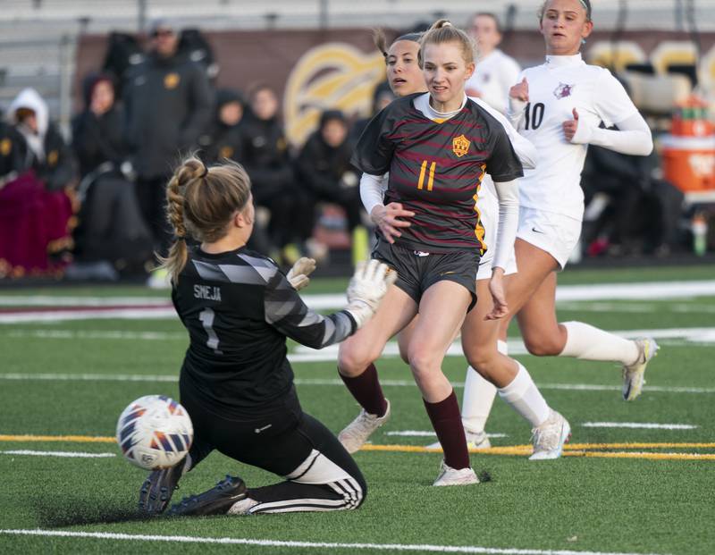 Richmond-Burton's Margaret Slove shoots past Prairie Ridge goalkeeper Grace Smeja to score a goal in the first half during their game on Wednesday, April 5, 2023 at Richmond-Burton High School in Richmond. Ryan Rayburn for Shaw Local
