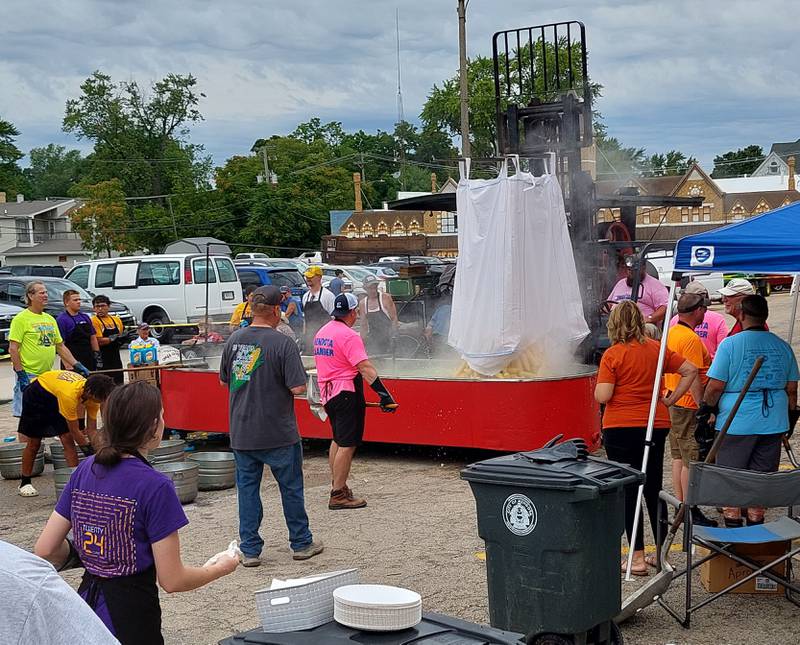 Sweet corn is dumped into a large vat to be boiled Sunday, Aug. 13, 2023, at the Mendota Sweet Corn Festival.