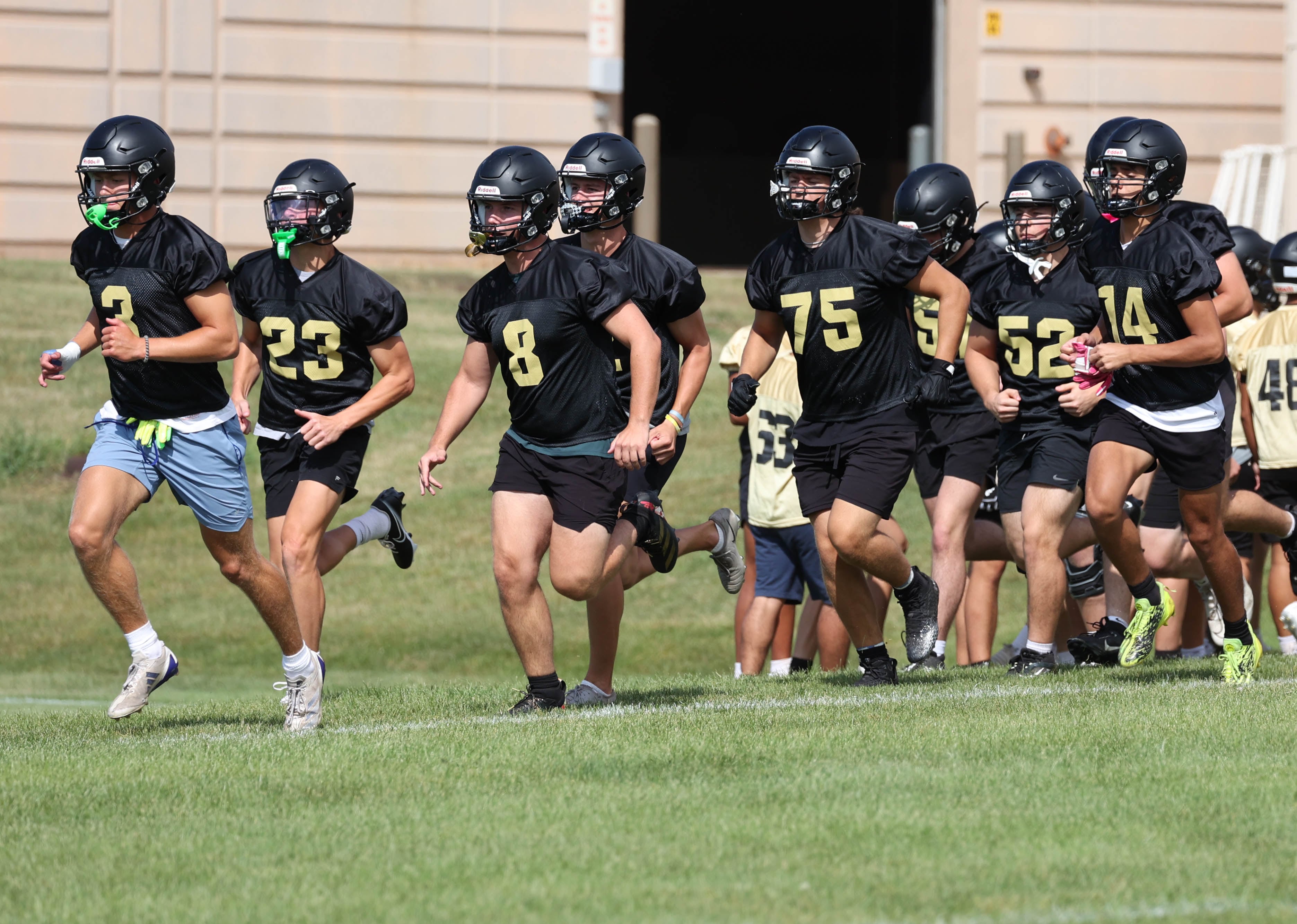 The Sycamore football team heads out onto the field Monday, Aug. 12, 2024, for the first practice of the regular season.