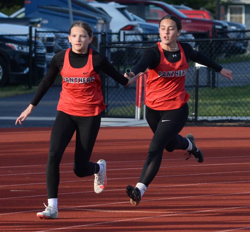 Erie-Prophetstown's Ellie Johnson hands the baton to Lexi Cappel in the 4x100 relay at the Ed Schmidt Invitational Track Meet at Erie High School on Friday, April 19, 2024.