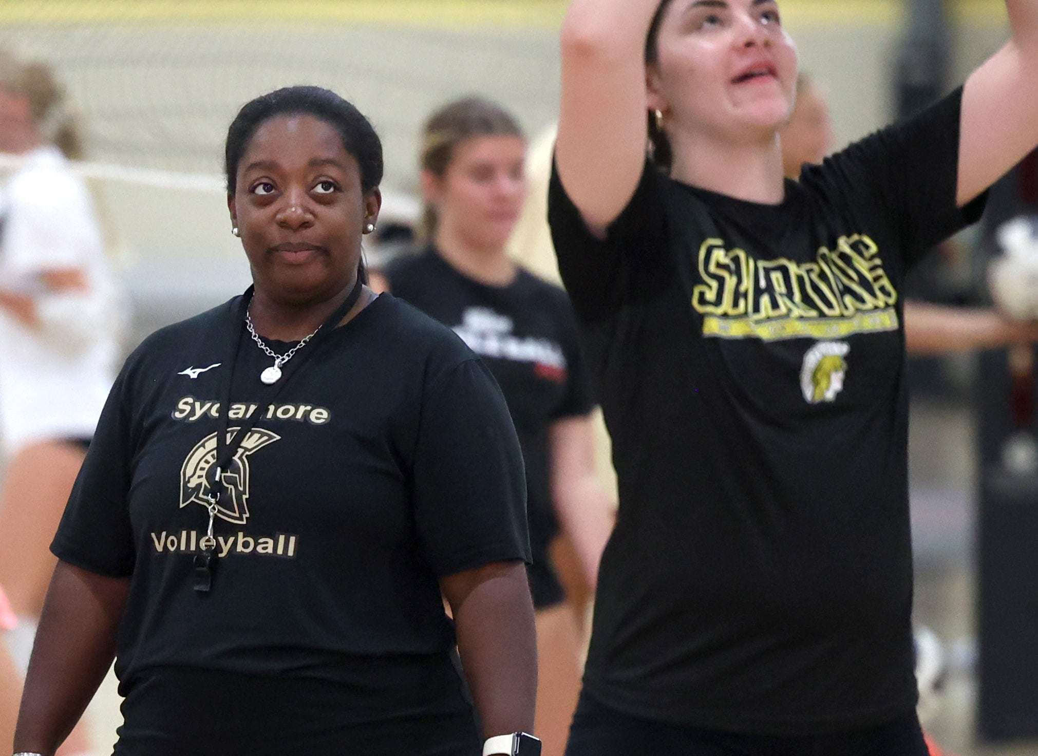 Sycamore volleyball head coach Jennifer Charles (left) watches players go through a drill during Sycamore High School volleyball camp Tuesday, July 23, 2024, at Sycamore High School.