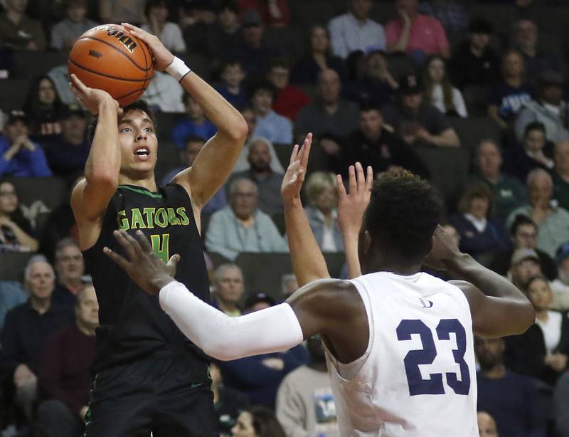Crystal Lake South's AJ Demirov shoots the ball over DePaul College Prep's Jaylan Mcelroy during the IHSA Class 3A Supersectional basketball game on Monday, March 4, 2024, at NOW Arena in Hoffman Estates.