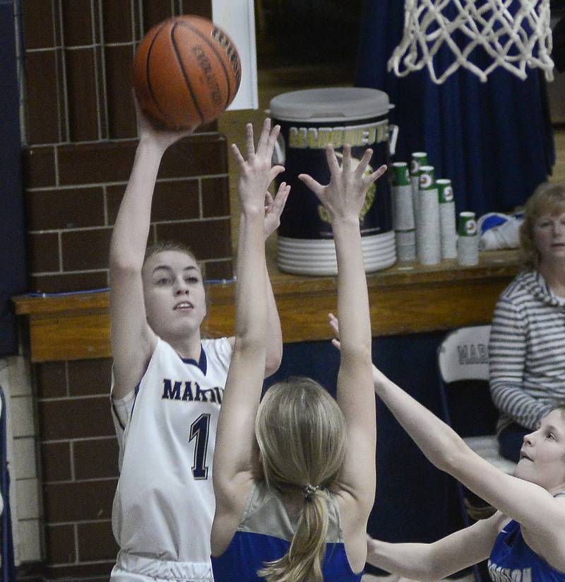 Marquette’s Lily Craig shoots over the reach of Princeton’s Erin May and Camryn Driscoll during the 1st period in Bader Gymnasium on Saturday, Jan. 7, 2023 at Marquette High School.