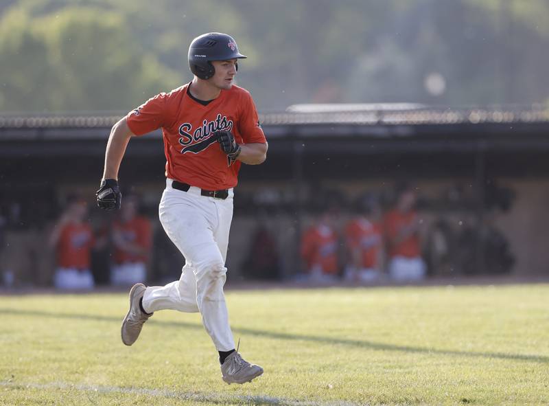 St. Charles East's Mac Paul (14) runs after getting a hit during the Class 4A York regional semi-final between Wheaton Warrenville South and St. Charles East in Elmhurst on Thursday, May 23, 2024.