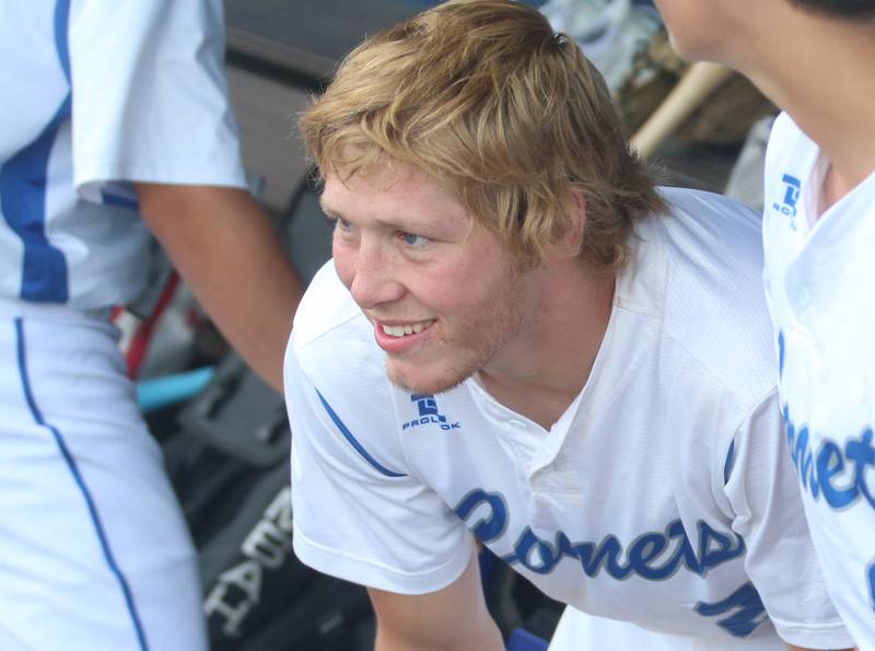 Newman's Daniel Kelly smiles while watching the game from the dugout during the Class 2A semifinal game on Friday, May 31, 2024 at Dozer Park in Peoria.