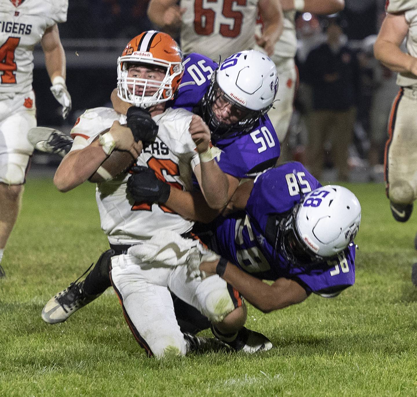 Byron QB Andrew Talbert is brought down by Dixon’s Aidan Howard and Exzavier Diaz Friday, Oct. 18, 2024, at A.C. Bowers Field in Dixon.