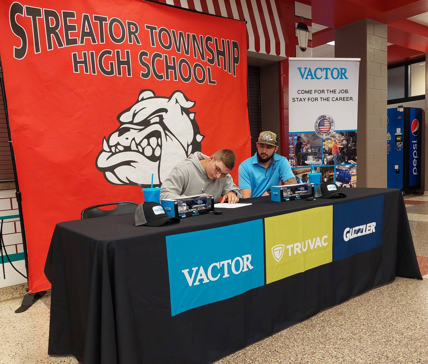 Graduating senior Nathan Pratt signs his intent to work at Vactor Manufacturing on Tuesday, May 14, 2024, at Streator High School.