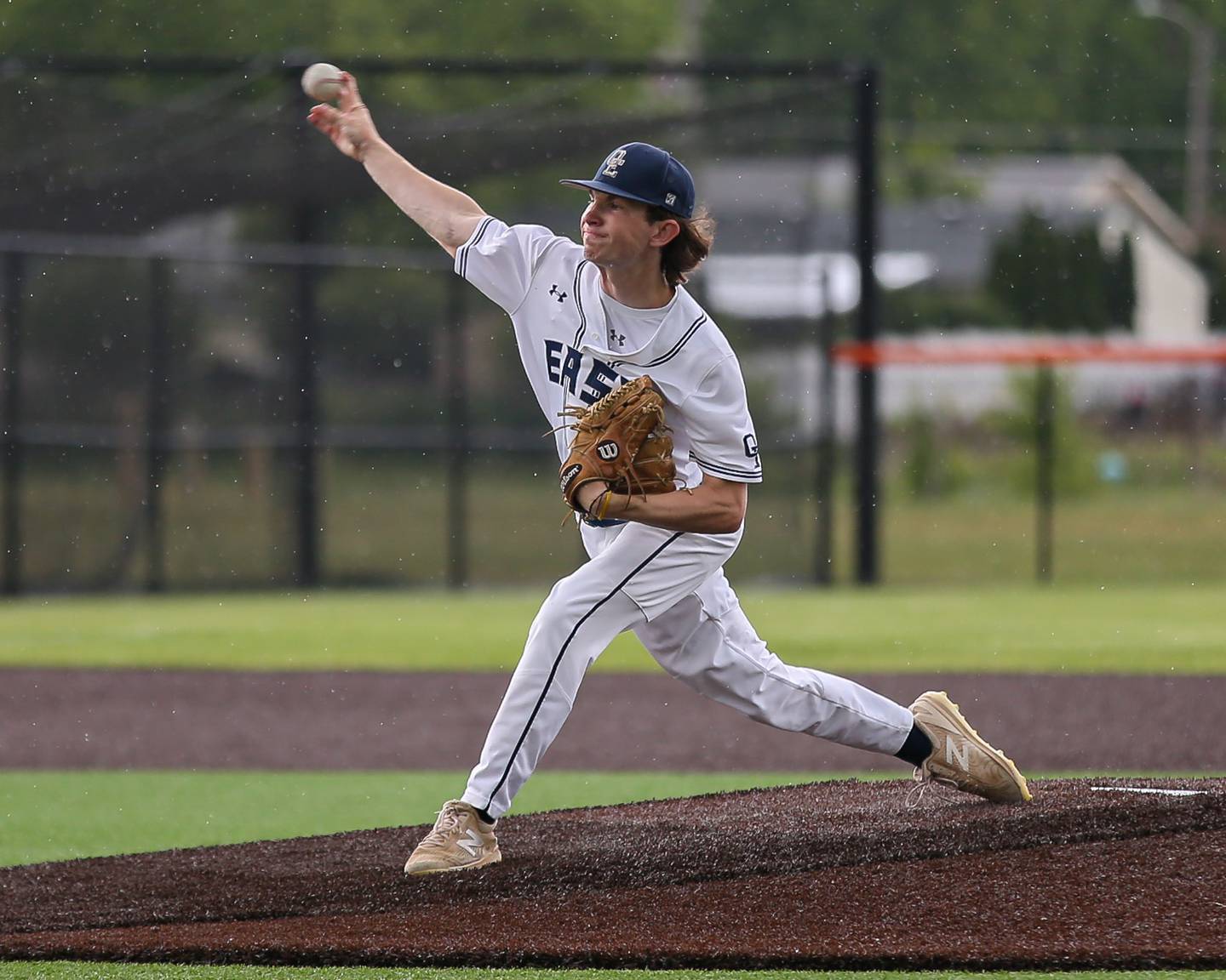 Oswego East's Patrick Flynn (12) delivers a pitch during Class 4A Romeoville Sectional semifinal between Oswego East at Downers Grove North on Wednesday, May 31, 2023.