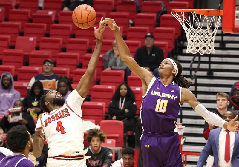 Northern Illinois Huskies forward Oluwasegun Durosinmi and Albany Great Danes forward Aaron Reddish go after a rebound during their game Tuesday, Dec. 20, 2022, in the Convocation Center at NIU in DeKalb.