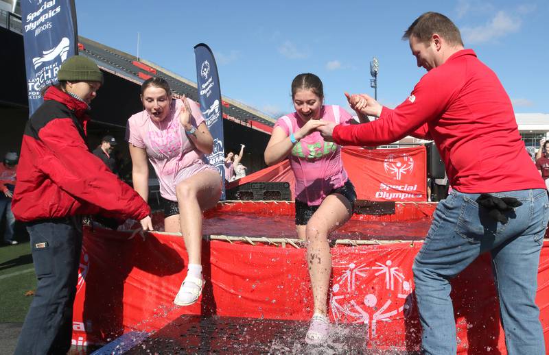 Members of the Alpha Sigma Alpha sorority are helped out of the water on a cold and windy Saturday, Feb 17, 2024, during the Huskie Stadium Polar Plunge at Northern Illinois University in DeKalb. The Polar Plunge is the signature fundraiser for Special Olympics Illinois.