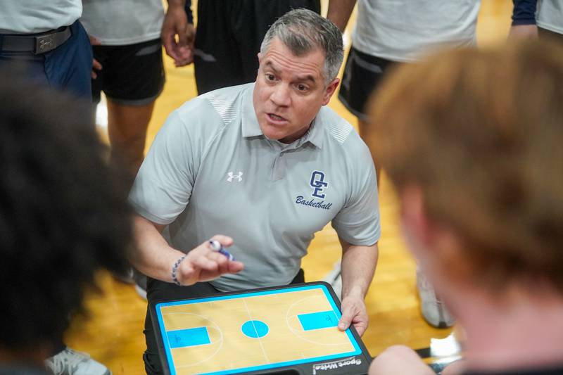 Oswego East's head coach Ryan Velasquez talks to his team during a Class 4A Oswego East regional final basketball game against Benet at Oswego East High School on Friday, Feb 23, 2024.