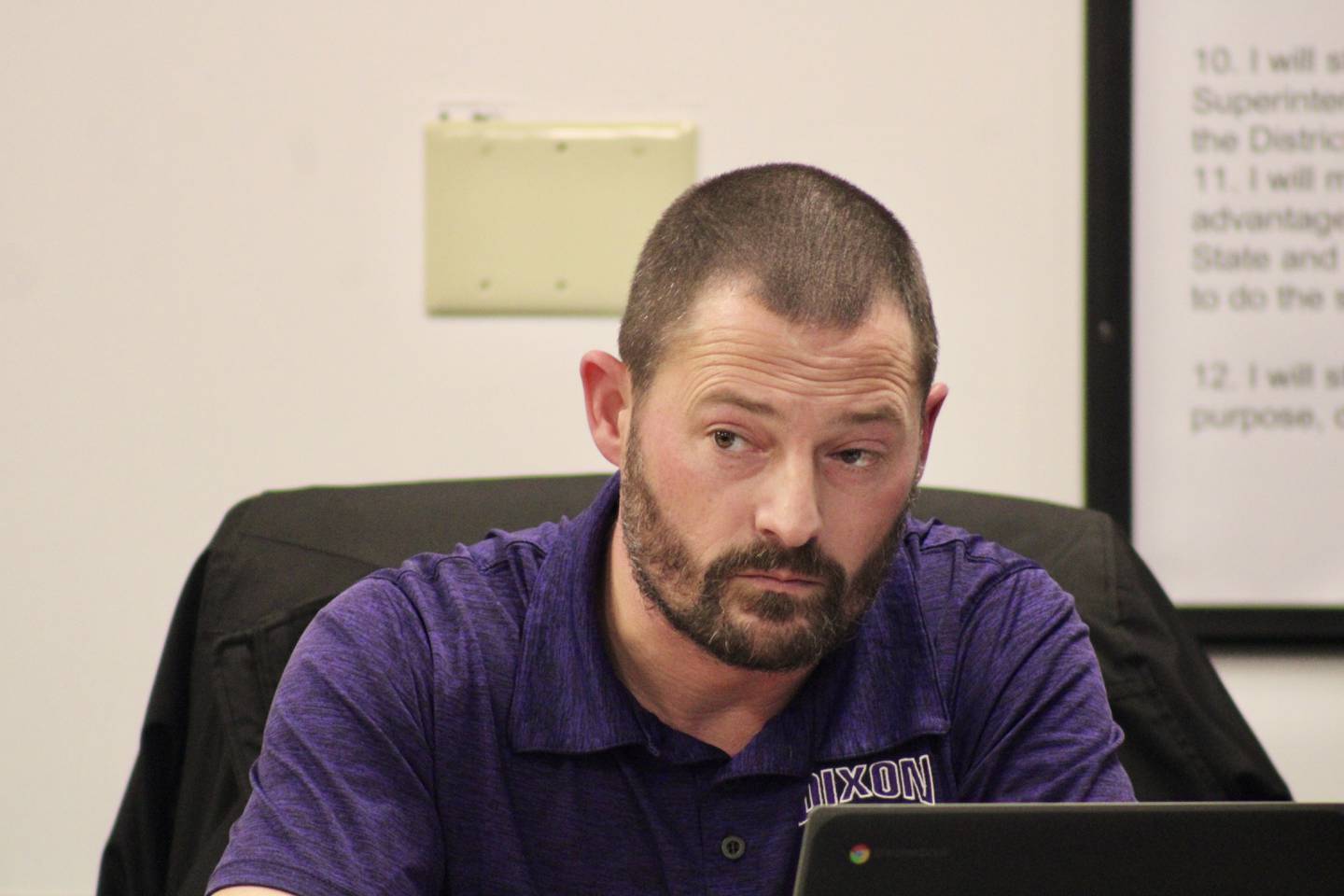 Dixon Public Schools board of education Secretary Brandon Rogers listens attentively as the administration explains the proposal concerning solar array site inspections during a meeting on Wednesday, Dec. 15, 2022.