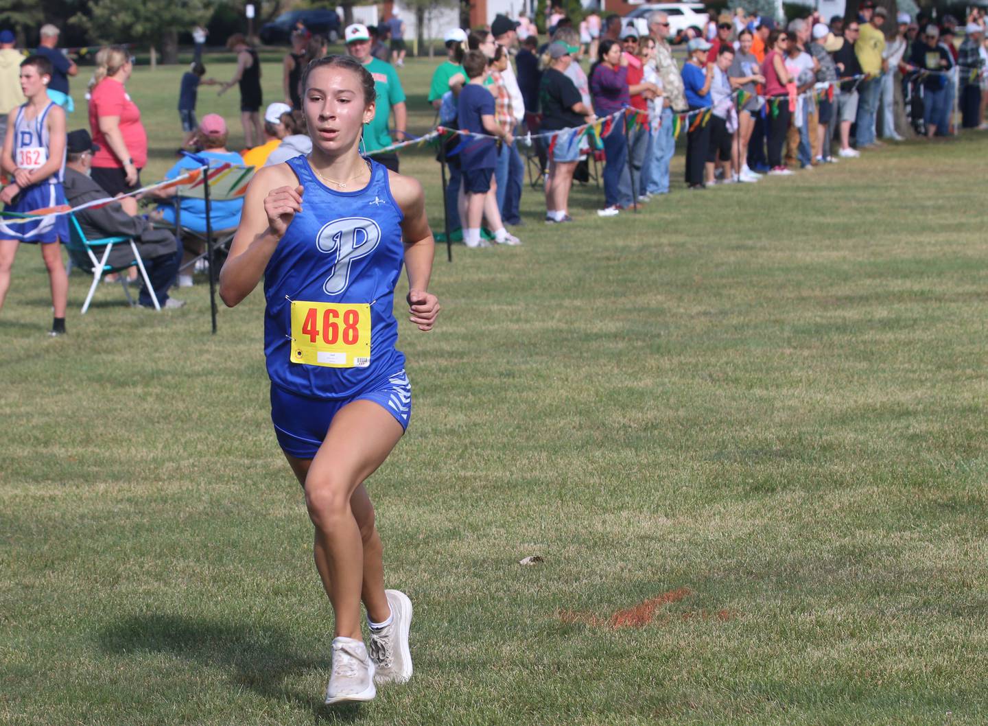 Princeton's Ruby Acker finishes in the Gary Coates Cross Country Invitational on Saturday, Sept. 14, 2024 Zearing Park in Princeton.