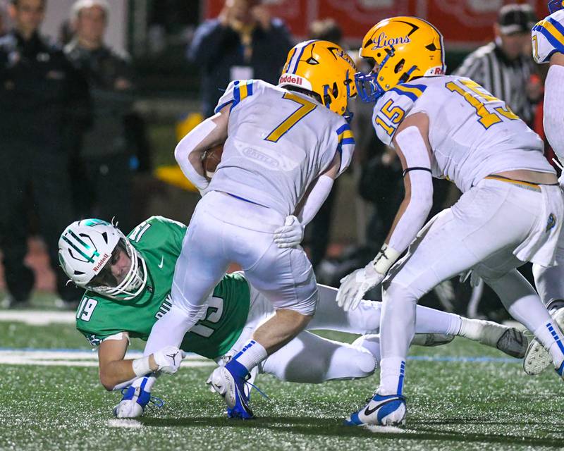 York High school Riggins Kohl brings down Lyons Township's Danny Carroll (7) during the game on Friday Oct. 18, 2024, held at York High School in Elmhurst.