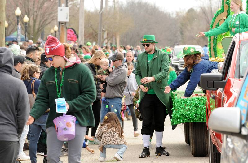 Uncommonly tall leprechaun Jake Galauner of the Parks and Recreation Department hands out candy during the Yorkville St. Patrick's Day parade on Hydraulic Avenue, Saturday, Mar. 16, 2024.