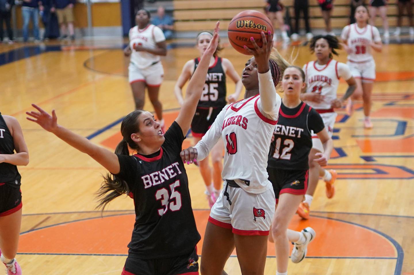 Bolingbrook's Trinity Jones (10) drives to the hoop against Benet’s Shannon Earley (25) during a Oswego semifinal sectional 4A basketball game at Oswego High School on Tuesday, Feb 20, 2024.
