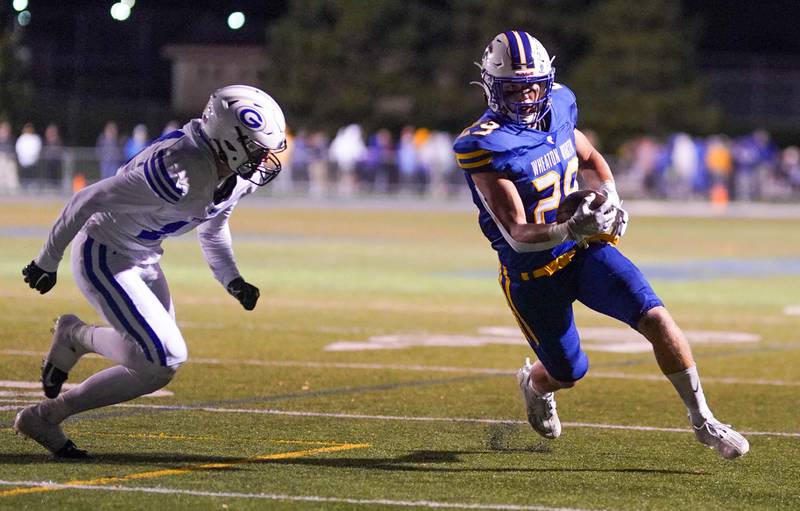 Wheaton North's Walker Owens (29) carries the ball late in the 4th quarter of play against Geneva during a football game at Wheaton North High School on Friday, Oct. 6, 2023.