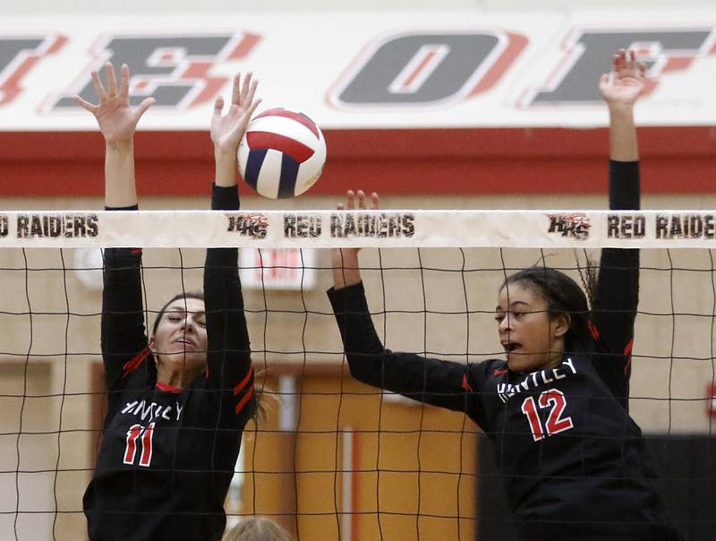 Huntley's Avery Gonzalez and Huntley's Morgan Jones tries to block the ball during a Fox Valley Conference volleyball match against Crystal Lake Central Tuesday, Aug. 22, 2023, at Huntley High School.