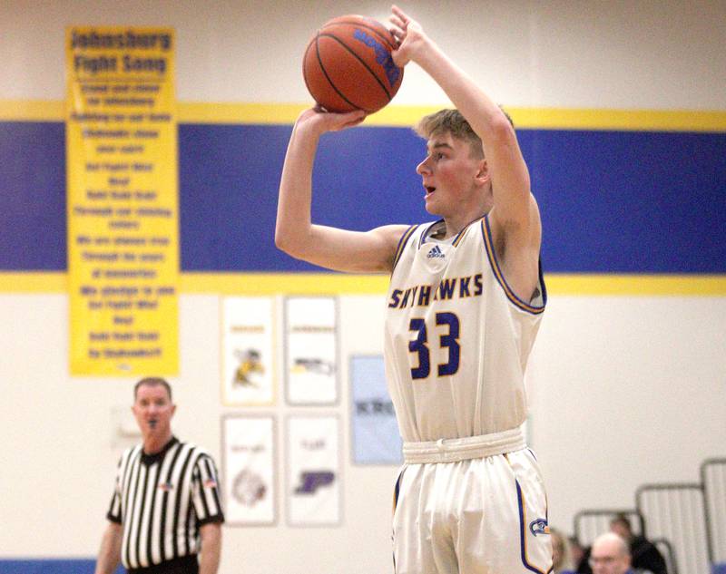 Johnsburg’s JT Schmitt takes an outside shot against Harvard in varsity boys basketball at Johnsburg Saturday.