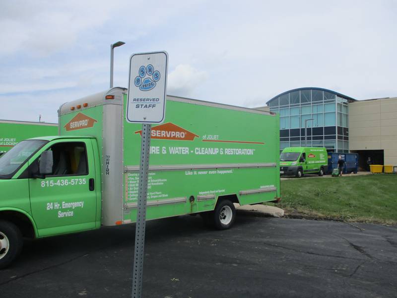 Nine Servpro trucks and vans were parked Tuesday at Plainfield South High School, which sustained roof damage in the storm that swept through Joliet on Monday. July 16, 2024