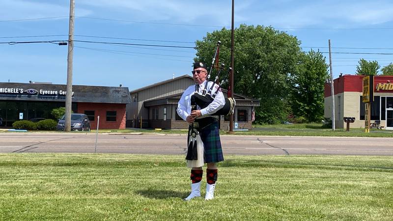 DeKalb firefighter Tom Conley performs "Amazing Grace" on bagpipes at the new first responders memorial outside Isaac Executive Suites, 2675 Sycamore Road, DeKalb, during a dedication ceremony held Sunday, May 19, 2024. The memorial was unveiled at the close of National Police Week.