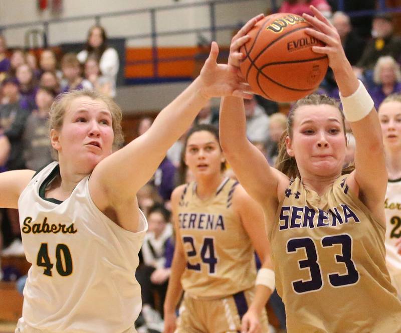 Serena's Jenna Setchell (33) and St. Thomas More's Ruari Quarnstrom (40) battle for the ball during the Class 1A Pontiac Super-Sectional on Monday, Feb. 27, 2023, at Pontiac Township High School.